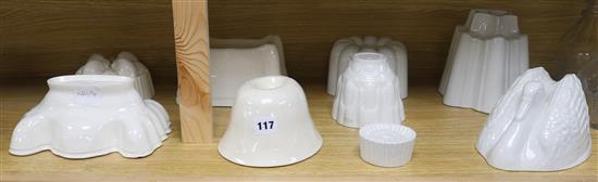 A collection of nine ceramic jelly moulds tallest 16cm